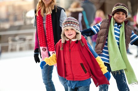 a family spends the day ice-skating outdoors Stock Photo - Budget Royalty-Free & Subscription, Code: 400-04847636