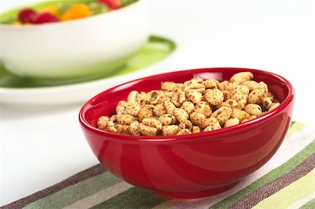 puffed wheat - Puffed wheat cereal in red bowl with fruit salad in the background (Selective Focus, Focus on the middle of the cereals) Stock Photo - Budget Royalty-Free & Subscription, Code: 400-04847688