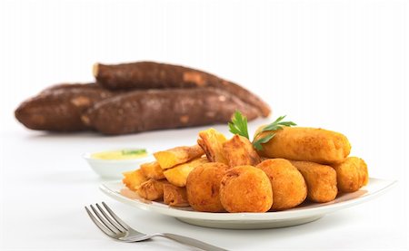 simsearch:400-04852542,k - Filled fried balls and sticks out of manioc with a dip and some manioc roots in the back (Selective Focus, Focus on the manioc balls) Stockbilder - Microstock & Abonnement, Bildnummer: 400-04847683