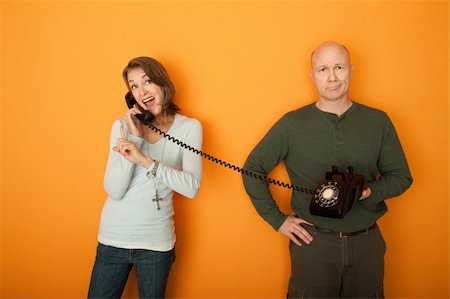 Happy Caucasian Woman on telephone conversation with bored man Stock Photo - Budget Royalty-Free & Subscription, Code: 400-04848050