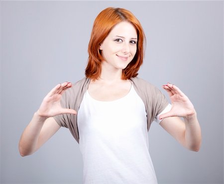 Red-haired businesswoman show something in air. Stock Photo - Budget Royalty-Free & Subscription, Code: 400-04848529