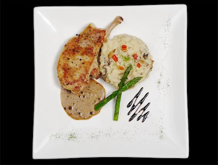 simsearch:400-04345345,k - Main dish: Chop with sauce, rice and asparagus on black background Photographie de stock - Aubaine LD & Abonnement, Code: 400-04848660