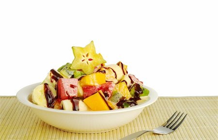 Fruit salad out of tropical fruits with chocolate sauce on top Stock Photo - Budget Royalty-Free & Subscription, Code: 400-04849142