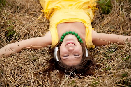 Young beautiful girl in yellow with headphones at field. Stock Photo - Budget Royalty-Free & Subscription, Code: 400-04849153