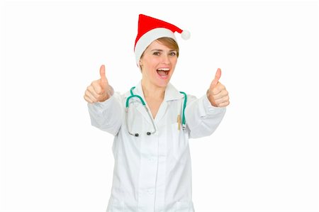 Happy medical doctor woman in Santa hat showing thumbs up gesture isolated on white Stock Photo - Budget Royalty-Free & Subscription, Code: 400-04849528