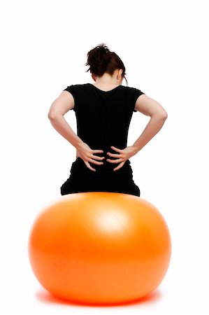 pain athlete - young woman with pain in the back sitting on orange exercise ball Stock Photo - Budget Royalty-Free & Subscription, Code: 400-04840006