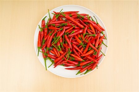 simsearch:400-04288181,k - Hot peppers in the plate on wooden table Photographie de stock - Aubaine LD & Abonnement, Code: 400-04840688