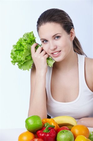 pretty women eating banana - Attractive young girl with fruits and vegetables on white background Photographie de stock - Aubaine LD & Abonnement, Code: 400-04840764
