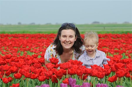 Mother with son in the red tulips field Stock Photo - Budget Royalty-Free & Subscription, Code: 400-04841118