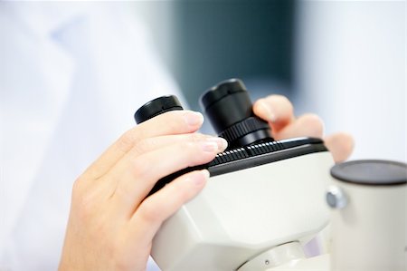 Close-up of a female scientist looking through a microscope in her laboratory Stock Photo - Budget Royalty-Free & Subscription, Code: 400-04841336