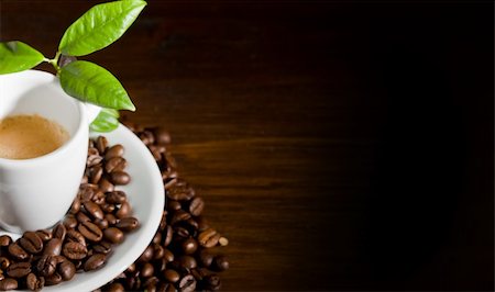 expresso bar - photo of espresso cup over coffee beans with green leaves Stock Photo - Budget Royalty-Free & Subscription, Code: 400-04842006