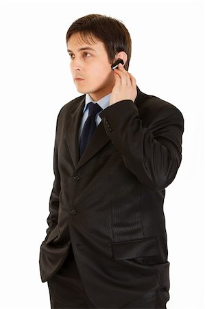 Concentrated modern businessman with handsfree isolated on white Stock Photo - Budget Royalty-Free & Subscription, Code: 400-04842465