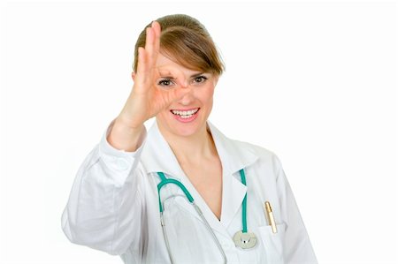 simsearch:400-04351236,k - Smiling medical doctor woman looking through ok gesture isolated on white Photographie de stock - Aubaine LD & Abonnement, Code: 400-04842473