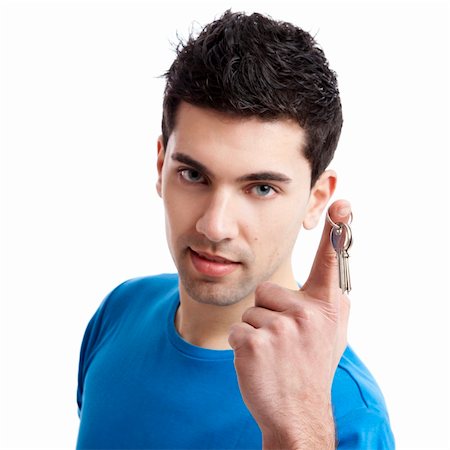 finger holding a key - Portrait of a handsome young man holding the keys of your home, focus is on the keys Photographie de stock - Aubaine LD & Abonnement, Code: 400-04842763