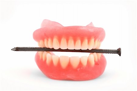 Plastic dentures and nail on a white background Fotografie stock - Microstock e Abbonamento, Codice: 400-04843010