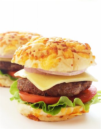simsearch:400-08253015,k - Tasty hamburgers with grilled patty, tomato, cheese and lettuce on white background Photographie de stock - Aubaine LD & Abonnement, Code: 400-04843151