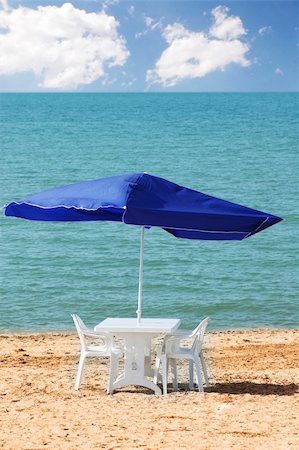 simsearch:400-04124750,k - Table, chairs and parasol on  the beach Stock Photo - Budget Royalty-Free & Subscription, Code: 400-04854027