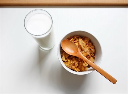 Glass of milk and corn flakes with wooden spoon Stock Photo - Budget Royalty-Free & Subscription, Code: 400-04854078