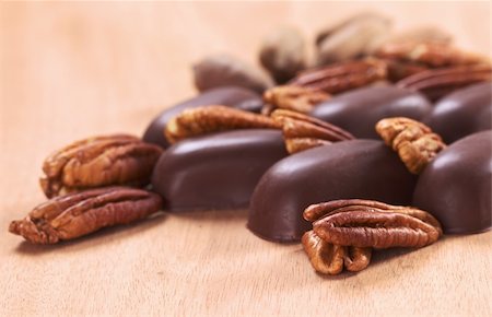 praline - Pecan nuts with pecan nut truffles on wood (Selective Focus, Focus on the pecan nut in the front) Stock Photo - Budget Royalty-Free & Subscription, Code: 400-04854610