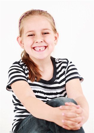 Happy girl with her first missing tooth Stock Photo - Budget Royalty-Free & Subscription, Code: 400-04854975