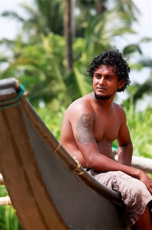 The young man sitting by a boat. Sri Lanka Stock Photo - Budget Royalty-Free & Subscription, Code: 400-04854982