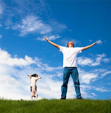 young man relax on the green field with his dog Stock Photo - Budget Royalty-Free & Subscription, Code: 400-04855337