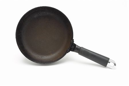 Old rusty frying pan standing on the side on white background Stock Photo - Budget Royalty-Free & Subscription, Code: 400-04855662