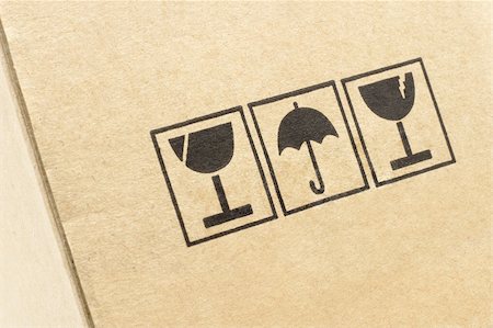 paper umbrella - Close up of caution symbols printed on carton box Stock Photo - Budget Royalty-Free & Subscription, Code: 400-04855717
