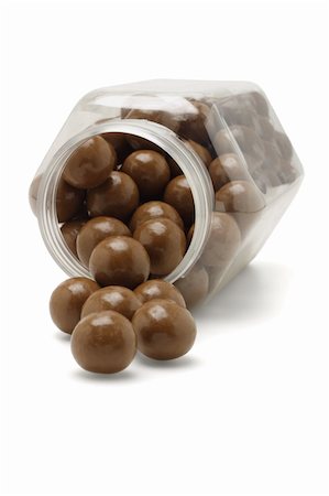 spill milk - Chocolate balls spilling out from fallen plastic container Stock Photo - Budget Royalty-Free & Subscription, Code: 400-04855883