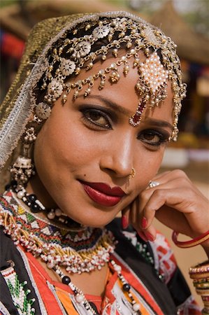 dancers of rajasthan - Beautiful Kalbelia dancer in ornate black costume trimmed with beads and sequins at the Sarujkund Fair near Delhi in India. Photographie de stock - Aubaine LD & Abonnement, Code: 400-04856366