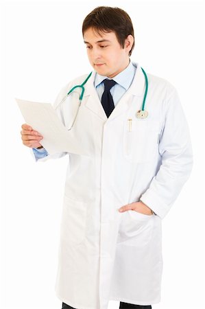 simsearch:400-05745246,k - Concentrated medical doctor reading document isolated on white Photographie de stock - Aubaine LD & Abonnement, Code: 400-04856983