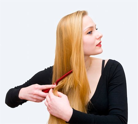 The young girl combs hair a crest Stockbilder - Microstock & Abonnement, Bildnummer: 400-04857222