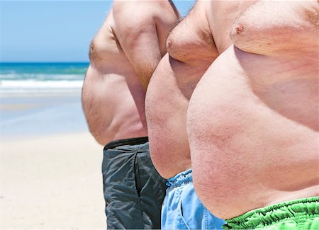 Close up of three obese fat men of the beach Fotografie stock - Microstock e Abbonamento, Codice: 400-04857545