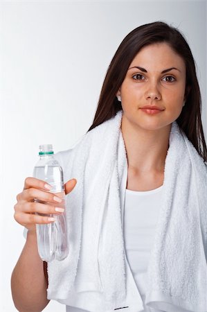 shyshka (artist) - Portrait of a young woman with towel and bottle of water over white Photographie de stock - Aubaine LD & Abonnement, Code: 400-04857893