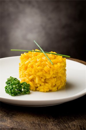 photo of delicious yellow risotto with saffron on wooden table Stockbilder - Microstock & Abonnement, Bildnummer: 400-04859374