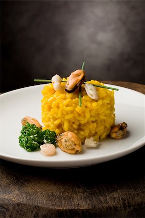 photo of delicious risotto with saffron and seafood on wooden table Stockbilder - Microstock & Abonnement, Bildnummer: 400-04859377