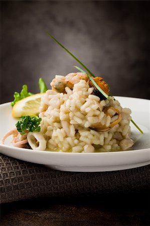 photo of delicious risotto with seafood and parsley on it Stockbilder - Microstock & Abonnement, Bildnummer: 400-04859381