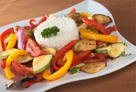 simsearch:400-04855335,k - Ratatouille of zucchini, eggplant, tomato, bell pepper and onion with cooked rice and parsley on top (Selective Focus, Focus on the front of the rice, the parsley on top and the vegetable around) Foto de stock - Royalty-Free Super Valor e Assinatura, Número: 400-04859669