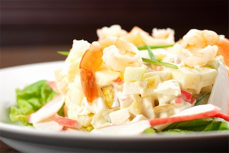 simsearch:400-09119781,k - Salad of shrimps, crab meat, cucumbers, apples, potatoes, lettuce, maize, eggs and mayonnaise Stock Photo - Budget Royalty-Free & Subscription, Code: 400-04859684