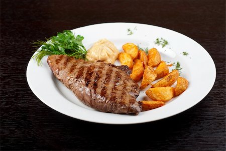 restaurant steak - Juicy beef steak stuffed with beef tongue and cheese served with potatoes, greenery and sauce Stock Photo - Budget Royalty-Free & Subscription, Code: 400-04859687