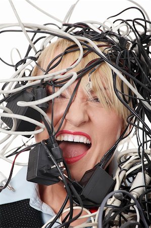 scream computer mad - Mature businesswoman's screaming in cables. Isolated on white background. Stock Photo - Budget Royalty-Free & Subscription, Code: 400-04850095