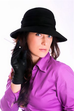 Portrait of a beautiful brunette young woman with black hat, gloves and cigars Photographie de stock - Aubaine LD & Abonnement, Code: 400-04850171