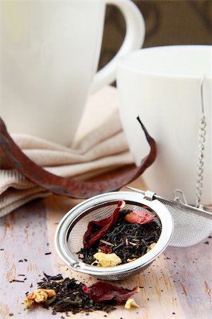 tea strainer with a fragrant black tea and cups in the background Stock Photo - Budget Royalty-Free & Subscription, Code: 400-04850311