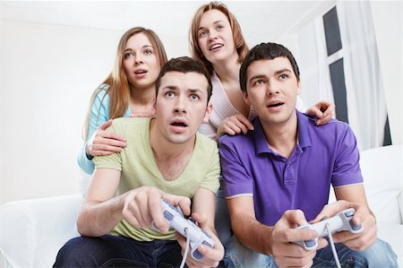 Young friends playing video games at home Stock Photo - Budget Royalty-Free & Subscription, Code: 400-04850664