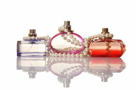 Perfume in a glass bottles and pearl beeds on white background Photographie de stock - Aubaine LD & Abonnement, Code: 400-04851434
