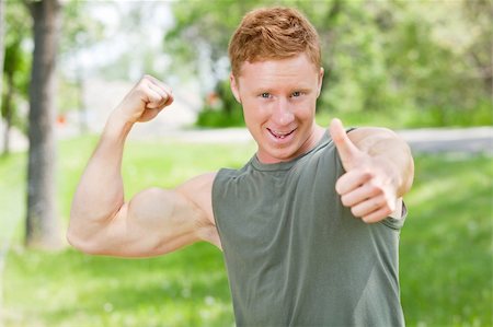 finger muscles - Handsome man showing thumbs up sign while flexing Stock Photo - Budget Royalty-Free & Subscription, Code: 400-04851968