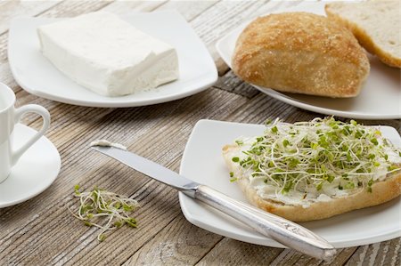 healthy breakfast concept - a roll with cream cheese and broccoli sprouts on a rustic wooden table Fotografie stock - Microstock e Abbonamento, Codice: 400-04852780