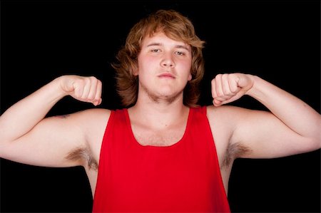 simsearch:400-04173797,k - A photograph of a yong man, in a red tank top, flexing. Stock Photo - Budget Royalty-Free & Subscription, Code: 400-04852866