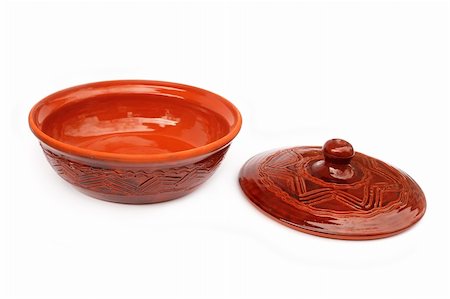 Annealed clay pot with a cover for cooking and prolonged storage of hot dishes. Isolated on white background Stock Photo - Budget Royalty-Free & Subscription, Code: 400-04853435