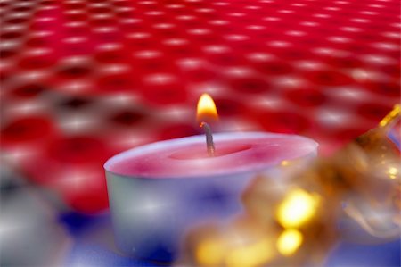 stocker (artist) - Burning candle and red flowers on a table Fotografie stock - Microstock e Abbonamento, Codice: 400-04853497